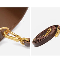 Brown leather bag strap with gold-tone metal clasps, detailed close-up on white background