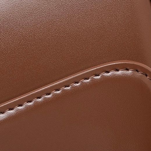 Close-up of brown leather bag with neat stitching detail