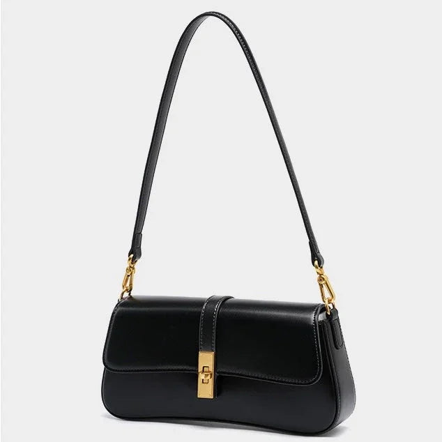 Black leather shoulder bag with gold hardware on a white background