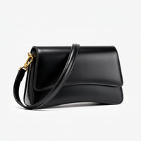 Black leather shoulder bag with gold hardware on white background