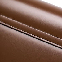 Close-up of brown leather with fine stitching, luxury bag material texture