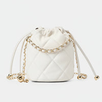 White quilted leather bucket bag with gold chain strap on white background