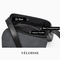 Véloisse black leather crossbody bag open, showing ID slot, main compartment, interior pocket