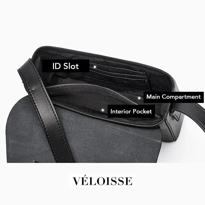 Véloisse black leather crossbody bag open, showing ID slot, main compartment, interior pocket