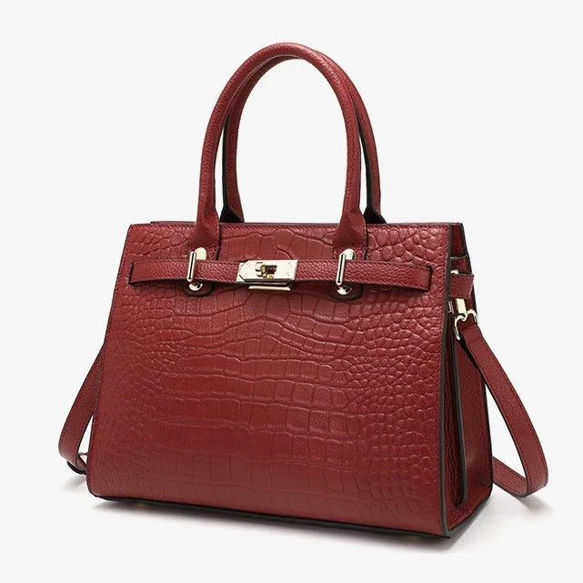 Red crocodile-embossed leather handbag with gold hardware and top handles