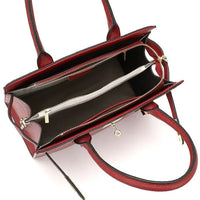 Open red leather handbag with dual handles, spacious compartments, and gold zippers