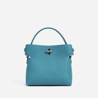 Blue pebbled leather handbag with top handle and silver hardware on white background