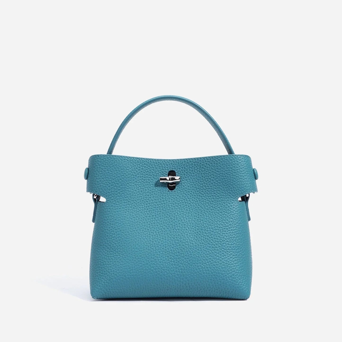 Blue pebbled leather handbag with top handle and silver hardware on white background