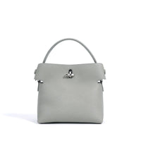Gray leather handbag with top handle and silver clasp on white background