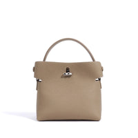 Taupe pebbled leather top handle handbag with silver hardware on white background