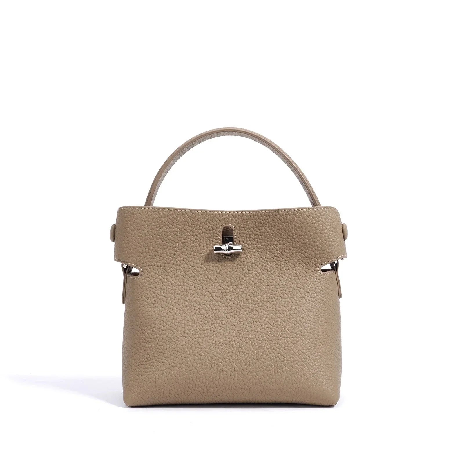 Taupe pebbled leather top handle handbag with silver hardware on white background