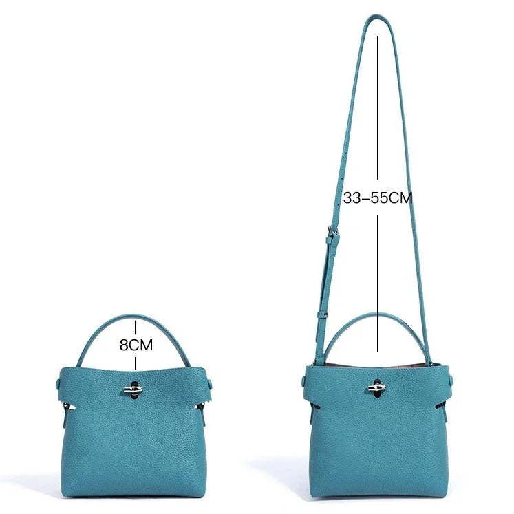 Blue leather handbag with top handle and adjustable shoulder strap, 8cm wide, 33-55cm strap