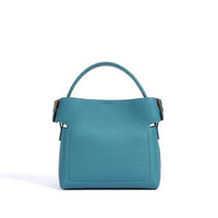 Blue leather handbag with top handle on white background