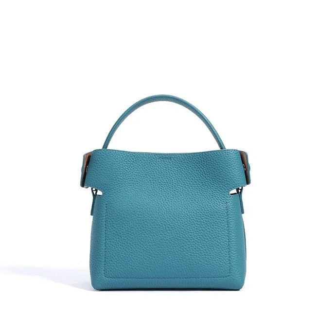 Blue leather handbag with top handle on white background
