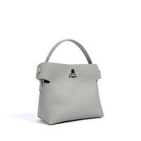 Light grey leather handbag with top handle and silver clasp on white background