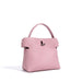 Light pink textured leather handbag with top handle on white background