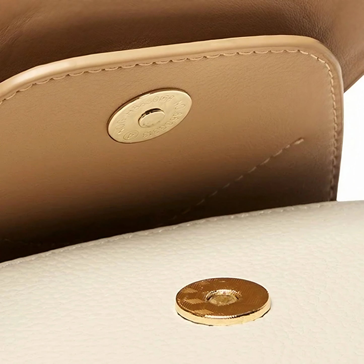 Closeup beige leather bag with gold magnetic snap closure