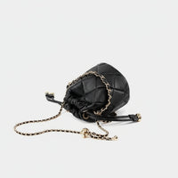 Black quilted leather bucket bag with gold chain strap on white background