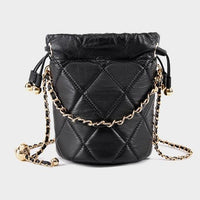 Black quilted leather bucket bag with gold chain strap on light background