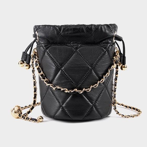 Black quilted leather bucket bag with gold chain strap on light background