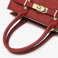 Red faux crocodile leather handbag with gold-tone lock and double handles