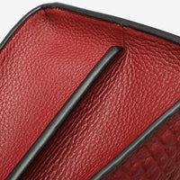 Red textured leather wallet interior with black trim and dual compartments