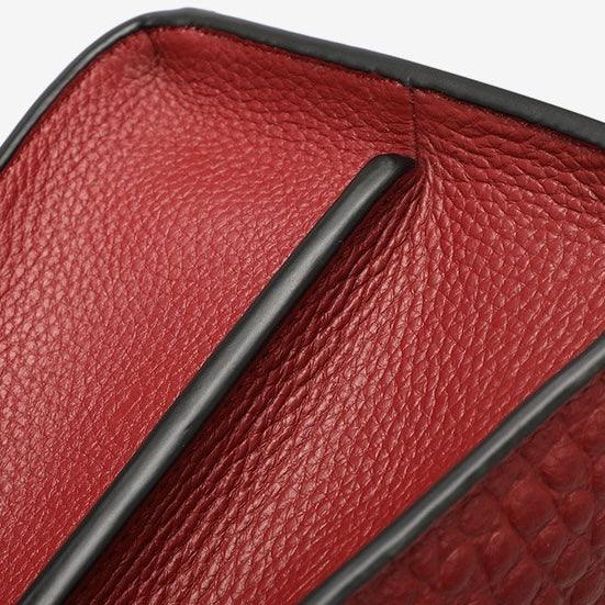 Red textured leather wallet interior with black trim and dual compartments