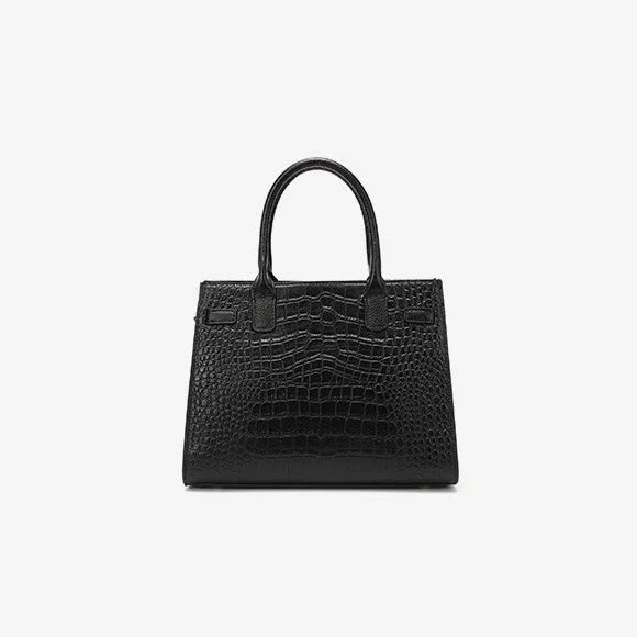 Black crocodile embossed leather handbag with top handles on white background