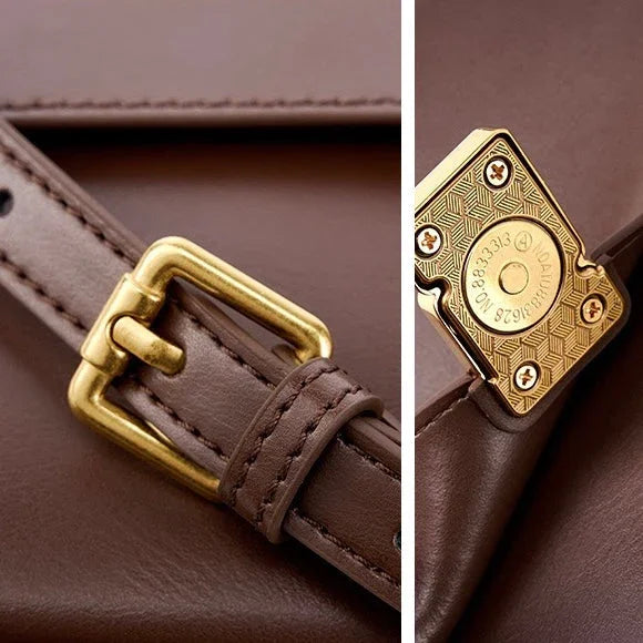 Close-up of brown leather bag with gold buckle and decorative metal clasp detail