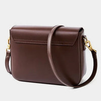 Brown leather crossbody bag with gold hardware on a white background