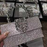 Sparkly rhinestone clutch bag with jeweled clasp and metallic beaded handle