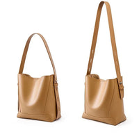 Tan leather shoulder bag with adjustable strap on white background