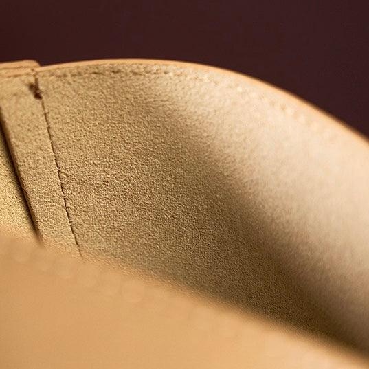 Close-up of tan suede leather bag interior with visible stitching detail