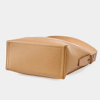 Tan leather crossbody bag with a rectangular base on a white background
