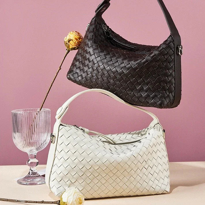 Black and white woven leather handbags with flowers on a pink background