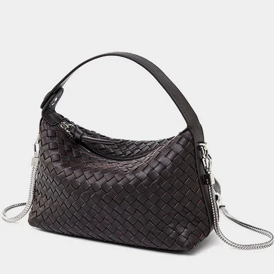 Dark brown woven leather handbag with top handle and silver chain strap on white background