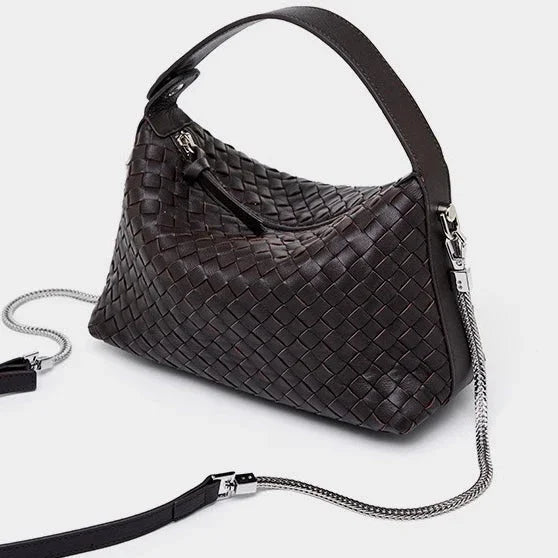 Dark brown woven leather handbag with silver chain strap on white background
