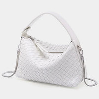 White woven leather handbag with zip closure and silver chain strap on a light background