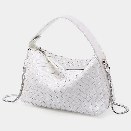 White woven leather handbag with zip closure and silver chain strap on a light background