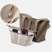 Beige tote bag with organizer insert, phones in pockets, and close-up of metal clasp.