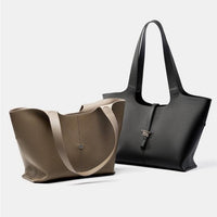 Taupe and black leather tote bags with textured finish on a white background