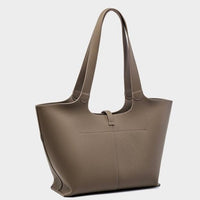 Taupe leather tote bag with double shoulder straps on a plain light background