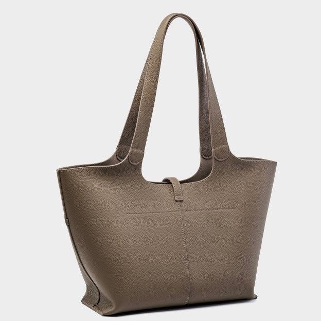 Taupe leather tote bag with double shoulder straps on a plain light background