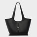 Black leather tote bag with metal detail and long handles on a plain background