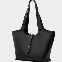 Black leather tote bag with double handles and silver clasp against white background