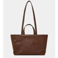 Brown leather tote bag with dual handles on a plain white background