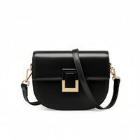 Black leather crossbody bag with gold buckle and adjustable strap on white background