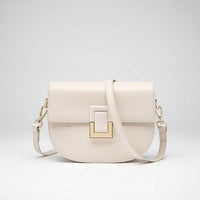 Cream leather crossbody bag with gold hardware and front square buckle detail