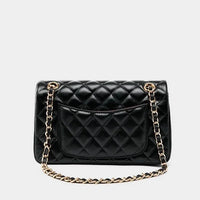 Black quilted leather handbag with gold chain strap and back pocket on white background