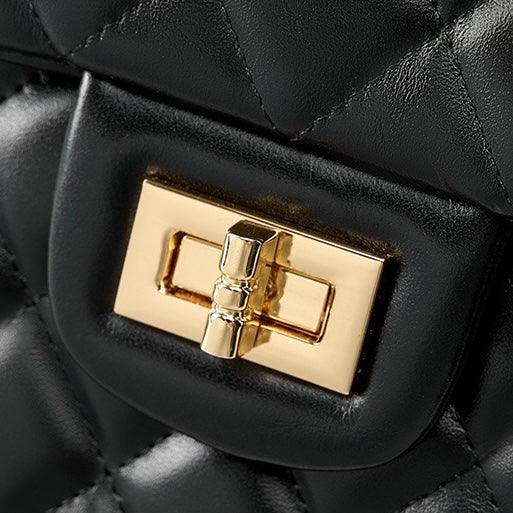 Black quilted leather bag with gold turn lock clasp close-up